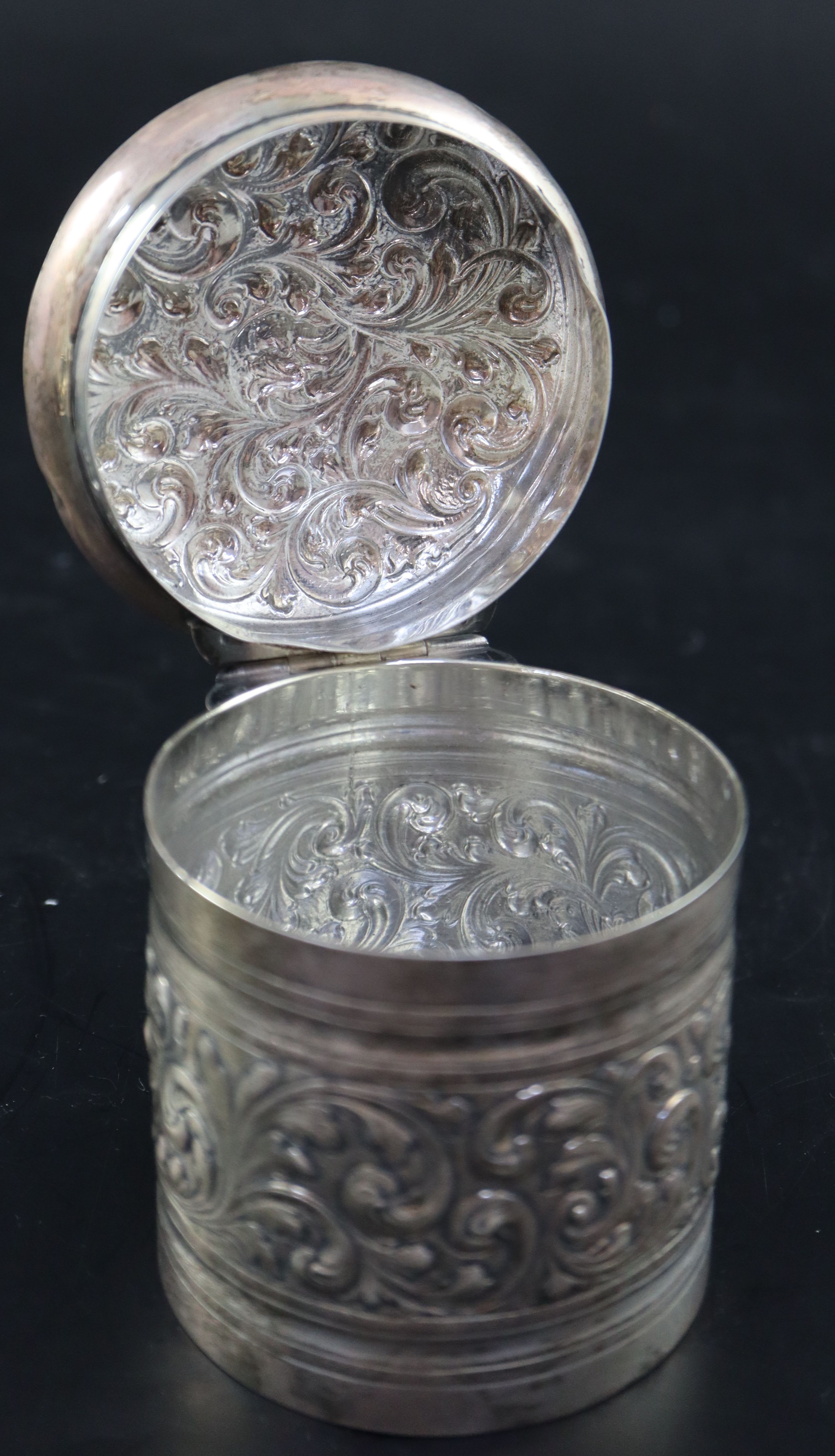 A Victorian embossed silver toilet jar, London, 1887, 93mm, 160 grams and a silver mounted clothes brush.